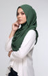 Woman wearing a Semi Instant Shawl Plain Hijan Emerald Green side drape view highlighting flowing edge and generous width with Pearl White blouse against a plain background