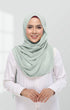 Studio portrait of a smiling woman wearing a dusty green semi-instant chiffon shawl styled neatly over a white blouse, soft natural makeup, clean light grey background, elegant and minimal fashion shoot