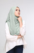 Woman wearing a Dusty Green shawl Hijab front drape view showing full length and chiffon texture and white blouse against a plain background