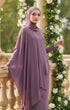 Woman in a Kebaya Moden Dusty Magenta model styling shot showing overall dress drape standing outdoors with floral decorations