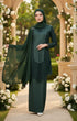 Woman in a Kebaya Moden Emerald Green flat lay showing full kebaya design and shape standing in a decorated outdoor setting with floral arrangements.