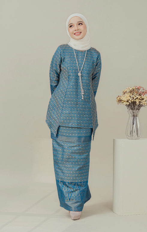 Model wear C Luxe Kurung Kedah Teal Blue displaying overall styling and drape