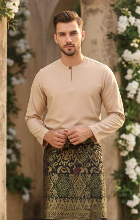 Man wearing a Baju Melayu Teluk Belanga Nude long-sleeve standing against a floral decorated background