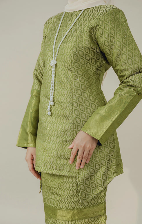 Fabric close up C Luxe Kurung Kedah Olive showing dyed brocade texture and pattern