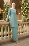 Woman in a Kurung Moden Plain Dusty green full outfit view standing on a balcony with floral decorations.
