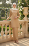 Woman in a Kurung Moden Plain Khaki outfit standing on a balcony with floral decorations