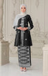 Woman wearing a Kebaya Black Silver displaying overall styling and drape a shawl hijab in an elegant interior setting.