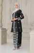 Woman wearing a Kebaya Black Silver showing premium songket texture and shawl white traditional outfit in an ornate room.