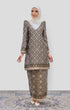 Woman wearing a Kurung Moden Black Gold Orchid showing brocade woven design and regular fit and instant shawl hijab on a white background