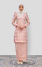 Woman wearing a traditional Kurung Moden Baby Pink Gold showing brocade woven design outfit with a Instant shawl plain on a white background