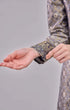 Fabric close up Rabai Kurung Moden Black Gold showing dyed brocade texture and gold accents