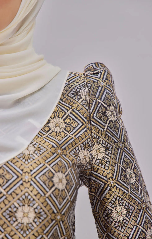 Fabric close up Kurung Moden Black Gold showing dyed brocade texture and gold accents