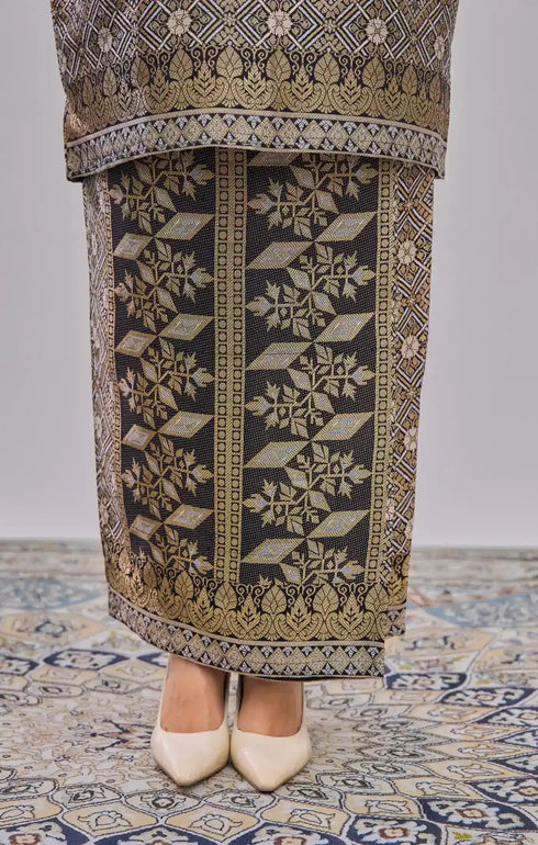 Fabric close up Kurung Moden Black Gold showing dyed brocade texture and gold accents on decorative floor