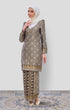 Model wearing Kurung Moden Black Gold displaying overall styling and elegant drape