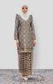 Front view Rabai Kurung Moden Black Gold showing brocade woven design and regular fit with a instant shawl white hijab on a plain background