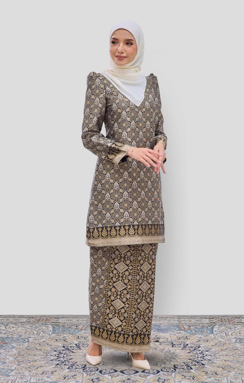 Model wearing Kurung Moden Black Gold Orchid displaying overall styling and drape