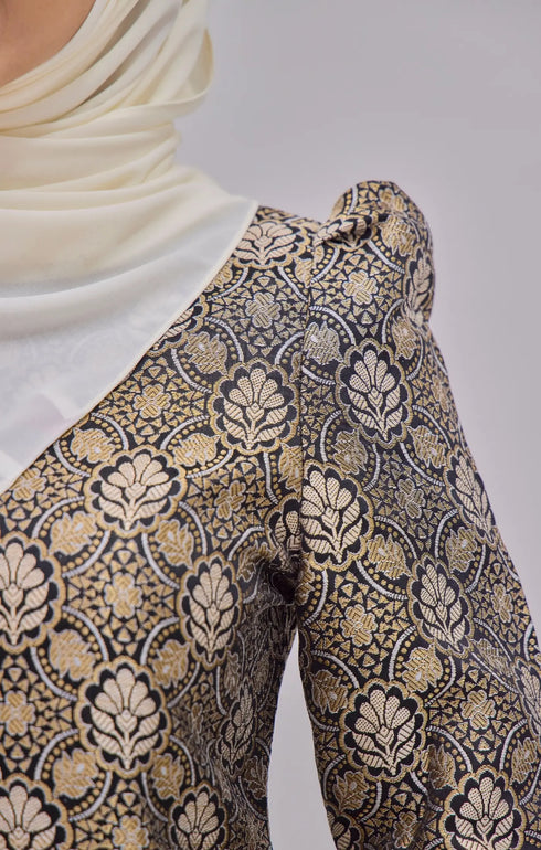 Kurung Moden Black Gold Orchid showing dyed brocade texture with a instant shawl white hijab on a gray background