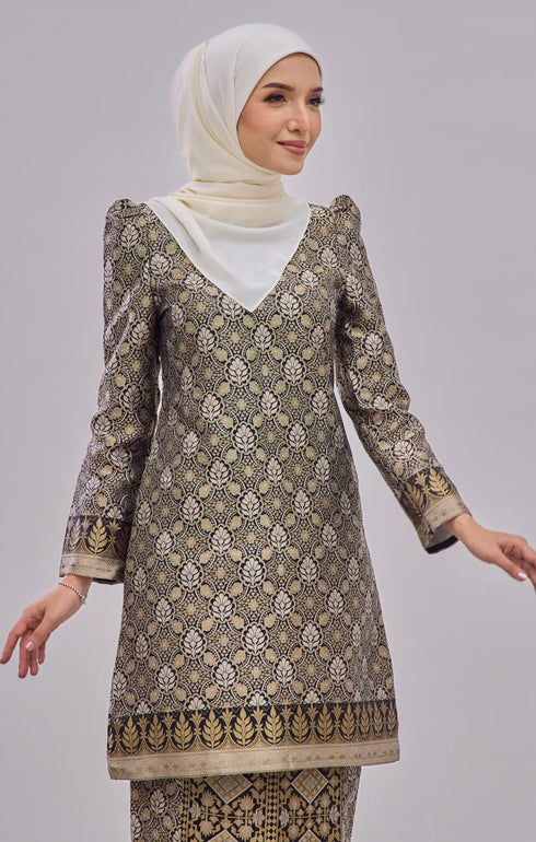 Close-up Kurung Moden Black Gold Orchid showing dyed brocade texture