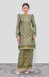 Woman wearing a Emerald Green Gold Traditional Kurung Moden showing brocade woven design on a white background