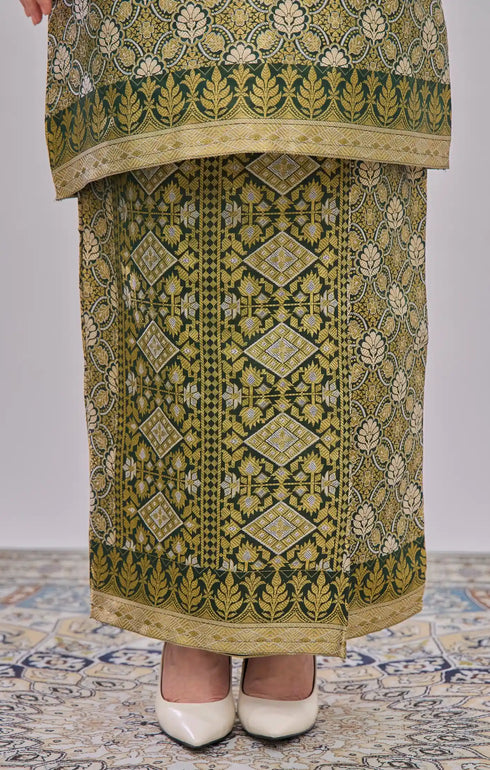 Traditional Kurung Moden Emerald Green Gold showing dyed brocade texture and gold highlights on a plain background