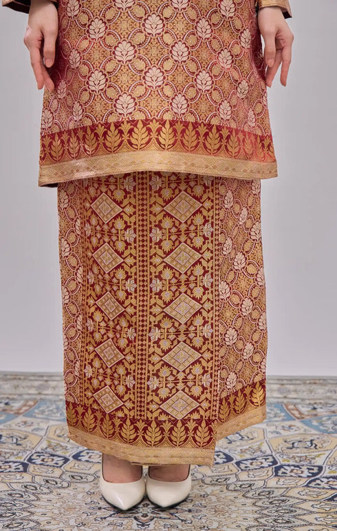 Kurung Moden Maroon Gold Orchid Traditional outfit on a person standing on a patterned floor.