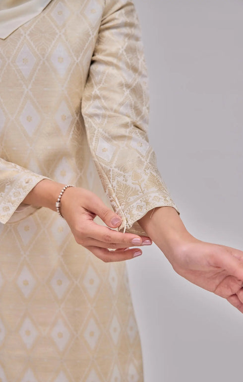 Fabric close up Kurung Moden Off White Gold showing dyed brocade texture and gold accents