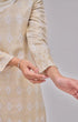 Fabric close up Kurung Moden Off White Gold showing dyed brocade texture and gold accents