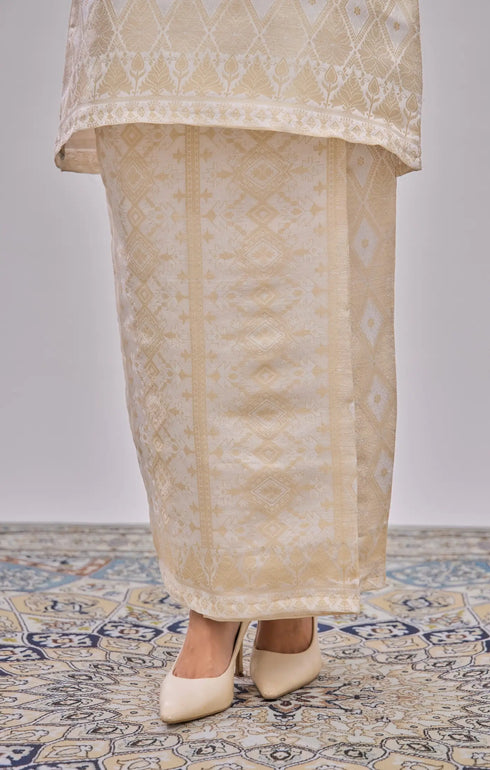 Kurung Moden Off White Gold showing dyed brocade texture on a plain background with patterned floor