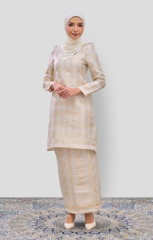 Model wearing Kurung Moden Off White Gold displaying overall styling and drape