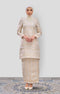 Woman wearing a Kurung Moden Off White Gold showing brocade woven design and regular fit with a pearl white matching hijab on a white background