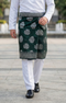 Man wearing Sampin Instant Kasturi Tenun Emerald Silver with Baju Melayu traditional outfit close-up showing embossed tenun fabric detail