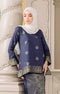 Fabric close up woman wearing a Kurung Kedah Blue Black Gold showing woven songket texture and gold pattern