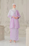 Woman wearing a Kebaya Lilac Purple Silver showing premium songket traditional outfit with a Instant Shawl white hijab in an ornate room.