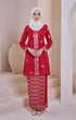 Woman wearing a Kebaya Red Chilli Silver showing premium songket weave and silver accents traditional outfit with instant shawl white hijab in a minimalistic setting