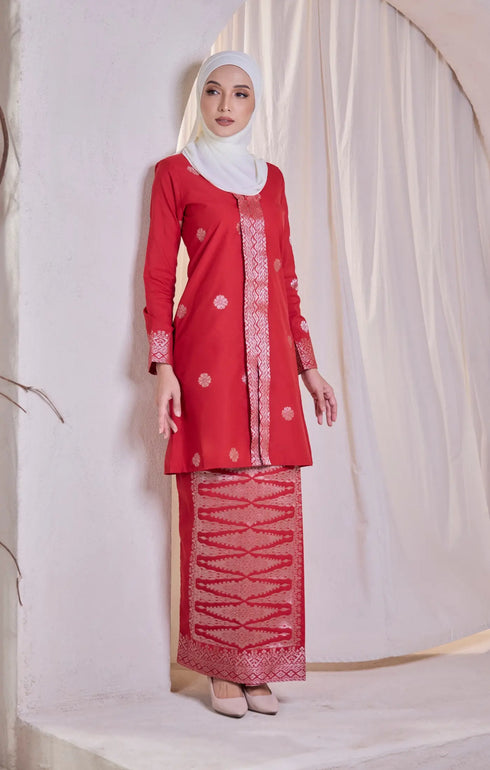 Model wearing Kebaya Red Chilli Silver displaying overall styling and drape with shawl hijab against a white background