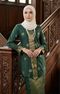 Fabric close up Seroja Kebaya Dark Emerald Green Gold showing songket woven texture and gold detailing
