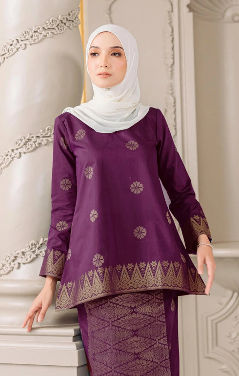Close up Aryana Kurung Kedah Magenta Gold showing woven songket texture and gold highlights