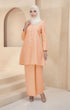 Kurung Riau Plain Peach styling shot showing shoulder puff and long straight sleeves