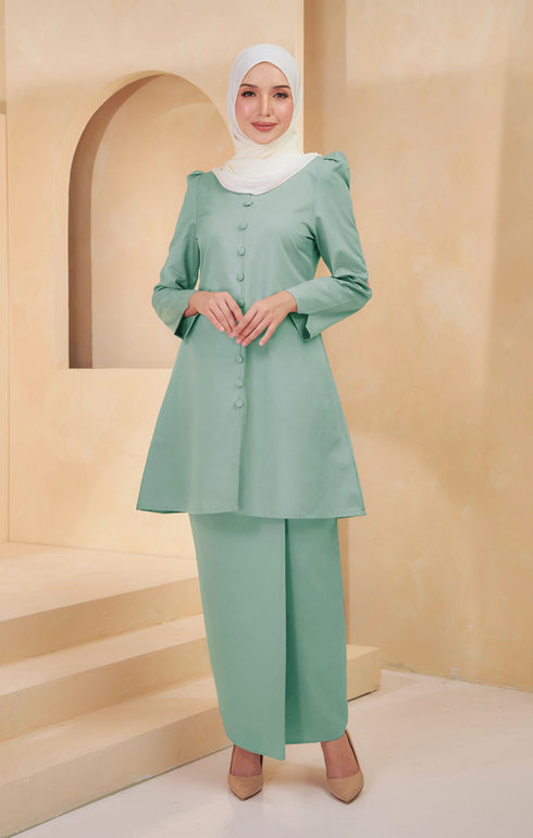 Kurung Riau Plain Sage Green front view on model showing round V neck and button front cut