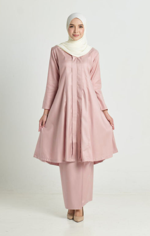 Model wearing Kebarung Klasik Rose Gold displaying overall styling and drape traditional outfit with a instant shawl white hijab on a white background