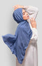 Woman wearing a Dusty Blue Royal Satin Shawl Plain Hijab side view highlighting flowy edge and generous width white outfit against a Plain background