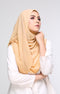 A woman wearing a Semi Instant Shawl Plain Nescafe Brown side view highlighting flowy edge and generous width around her shoulders, with a plain white top and blue eyeshadow.