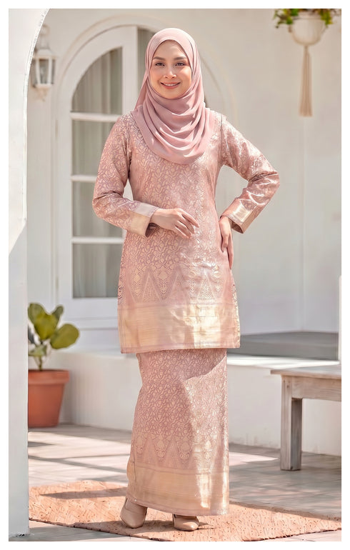 Model wearing Kurung Moden Baby Pink full outfit showing structured shoulder pad fit