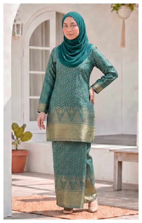 Woman wearing traditional Kurung Moden Teal Green full outfit view with lipat depan kain and lining